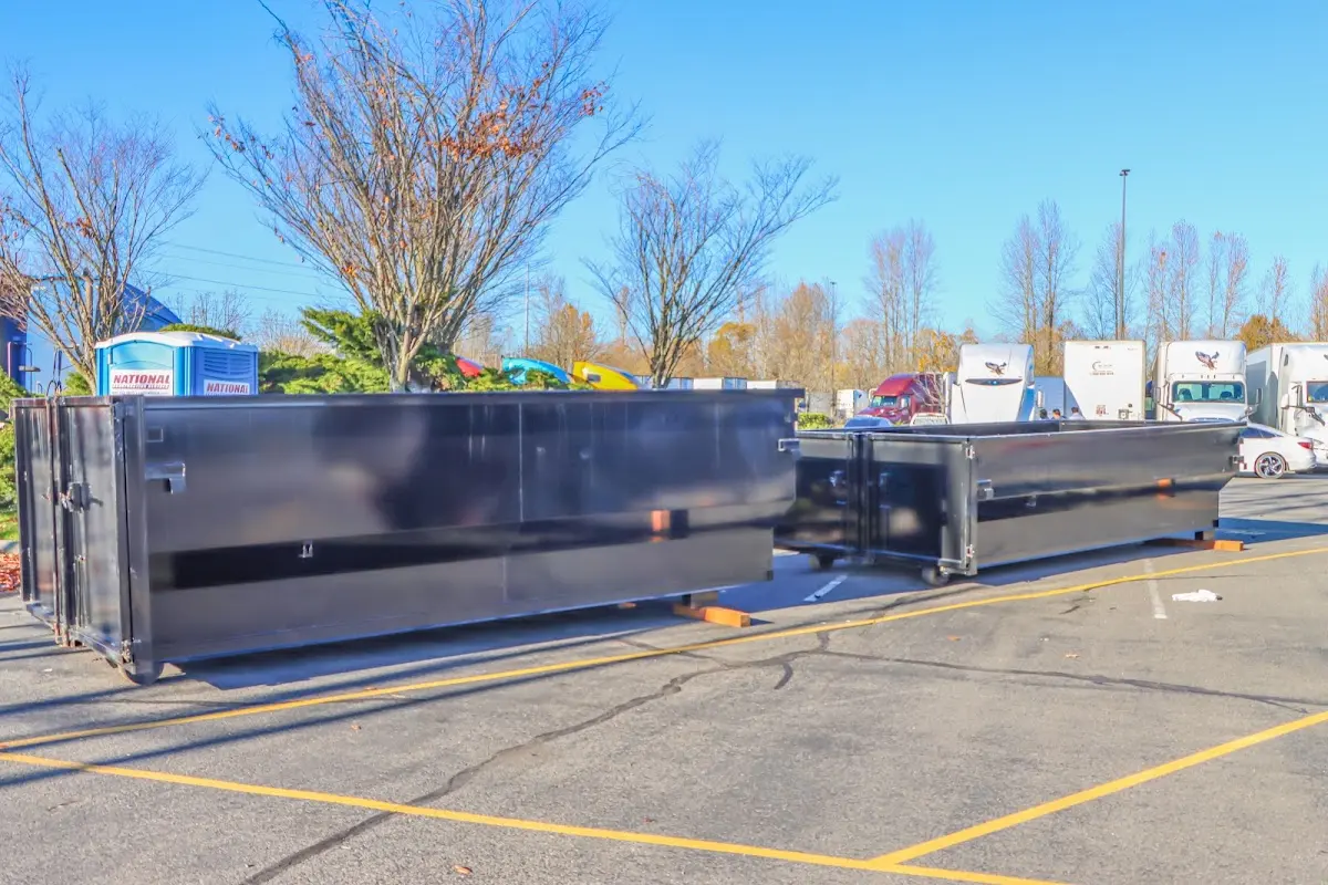 Professional dumpster rental service with roll-off container on residential driveway in Salem Lakes